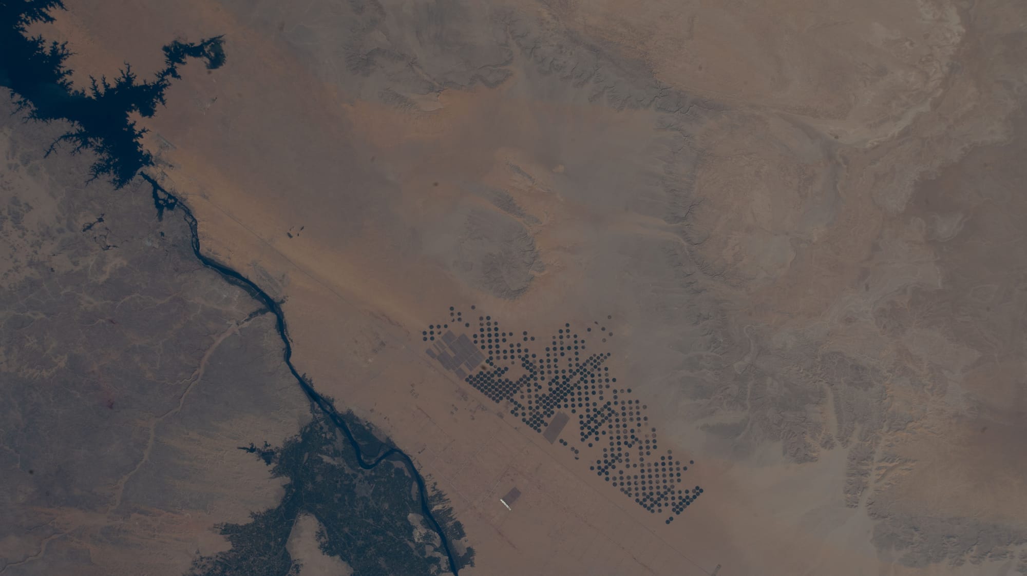 the Aswan High Dam seen from above, with the reservoir behind it